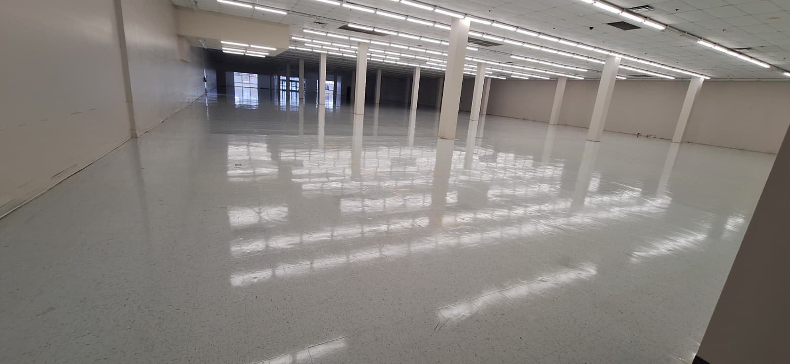 The same commercial floor after stripping and waxing by Levdok Services — high-gloss shine