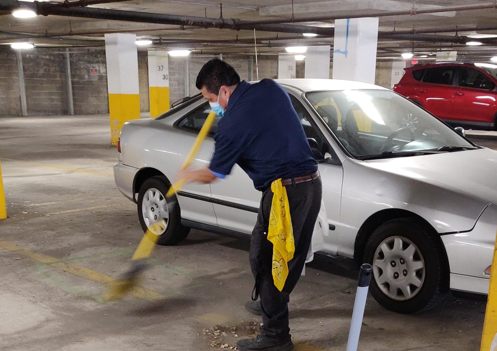 Levdok janitorial team member sweeping a parking garage at a Baltimore property