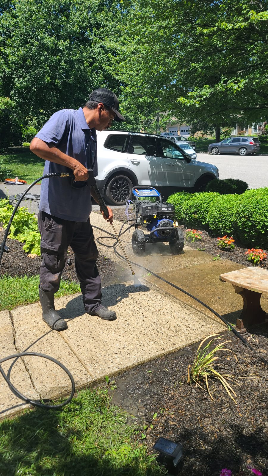 Levdok technician pressure washing a sidewalk at a Baltimore-area property
